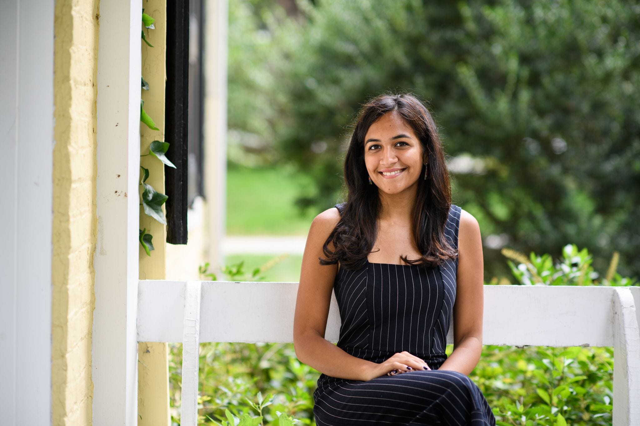 Student sitting outside Joseph Henry House